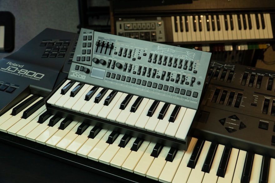 a close up of a keyboard near many other musical instruments